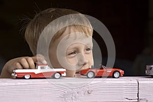 Little boy plays a toy car