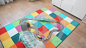 A little boy plays in the train, running after him to overtake