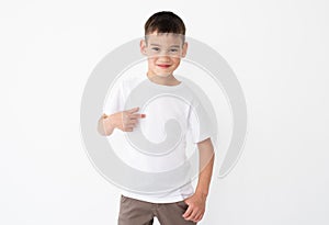 Little boy pointing at blank white tshirt photo