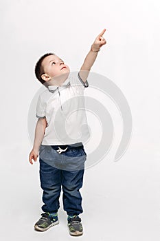 Little boy pointing by finger up and looking at stars.