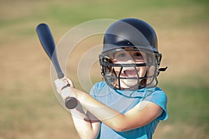 Little boy posing with a baseball bat. Portrait of kid playing baseball.