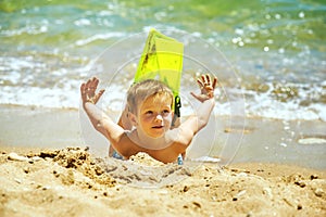 Little boy posing on the beach wearing snorkeling equipment. On the background of the sea