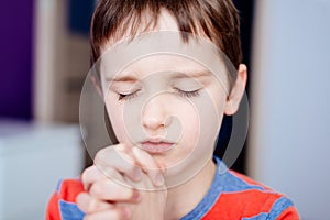 Little boy praying. Boy`s prayer.