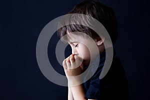 Little boy praying, child praying, background