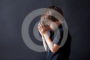 Little boy praying, child praying, isolated background