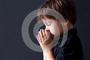 Little boy praying, child praying, isolated background