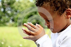 Little boy praying to God
