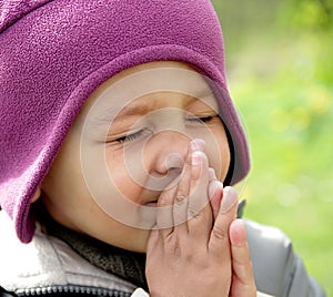 Little boy praying to God with hands held together stock photo