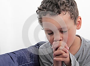 Little boy praying to God stock photo