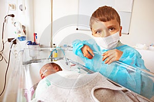 Little boy with premature infant brother, ICU