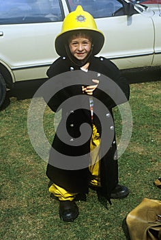 Little boy pretending to be a fireman in Brighton, England