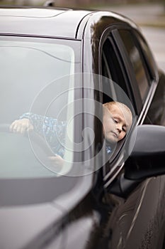 Little boy pretending to drive car