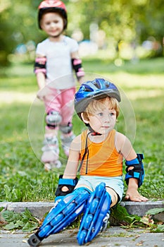 Little boy in protective equipment and rollers