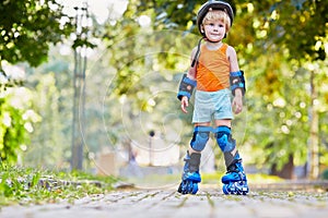 Little boy in protective equipment and rollers