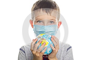 Little boy in protective sterile medical mask is holding a world globe. Save planet. The concept of preventing the spread of the