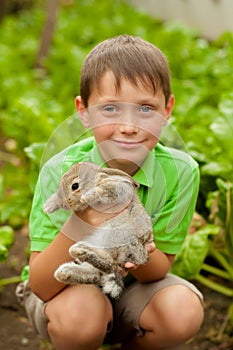 The little boy with a rabbit in the hands