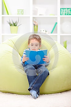 Little boy reading from book