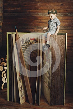 Little boy reading a book, study, knowledge symbol, bibliophile.