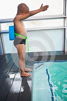 Little boy ready to dive in pool