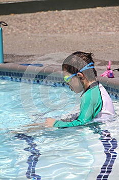 Little boy ready to swim in pool