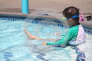 Little boy ready to swim in pool