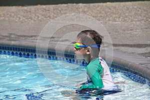 Little boy ready to swim in pool