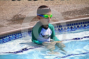 Little boy ready to swim in pool