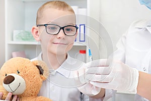 Little boy receiving vaccination at the clinic, close up