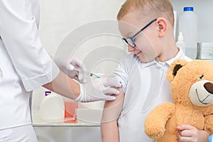 Little boy receiving vaccination at the clinic, close up