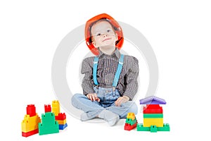 Little boy in a red construction hardhat on white background