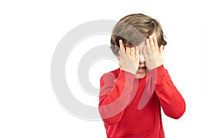 Little boy in red sweater, angry on white background