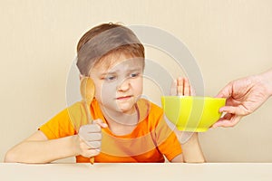 Little boy refuses to eat porridge