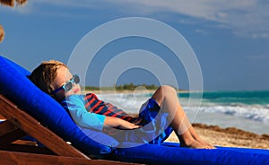 Little boy relaxed on summer beach