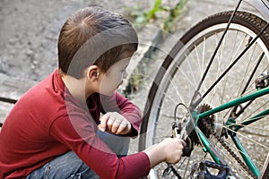 Little boy repair bicycle