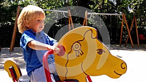 Little boy ridding a toy horse