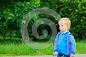 Little boy riding bike in the park