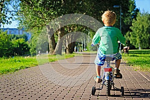 Little boy riding bike in the park