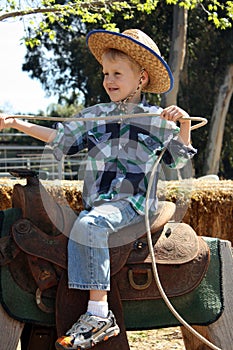 Little boy riding fake horse