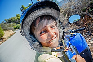Little boy riding quad bike. Cute child on quadricycle. Motor cross sports on Greece island. Kids summer vacation