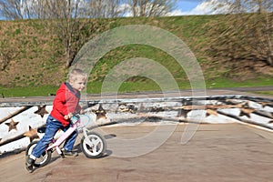 Little boy riding runbike