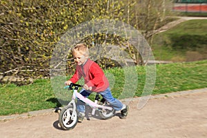 Little boy riding runbike