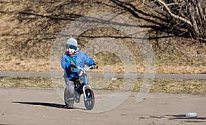 Little boy riding runbike