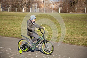 Little boy riding runbike, early sport. child learns to ride a bike