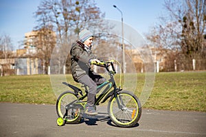 Little boy riding runbike, early sport. child learns to ride a bike