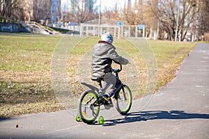 Little boy riding runbike, early sport. child learns to ride a bike