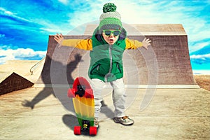 Little boy riding on steep hills to skateboard at the skate Park.Extreme sports.