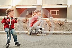 Little boy riding a toy scooter