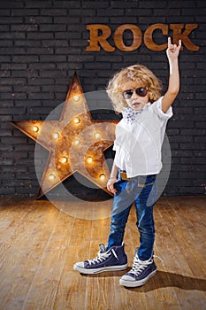 Little Boy Rock Star Giving The Rock And Roll Sign
