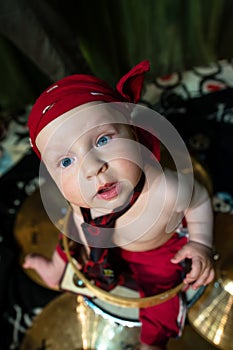 Little boy rocker drummer in red bandana and with drum