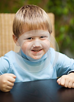 Little boy with roguish smile